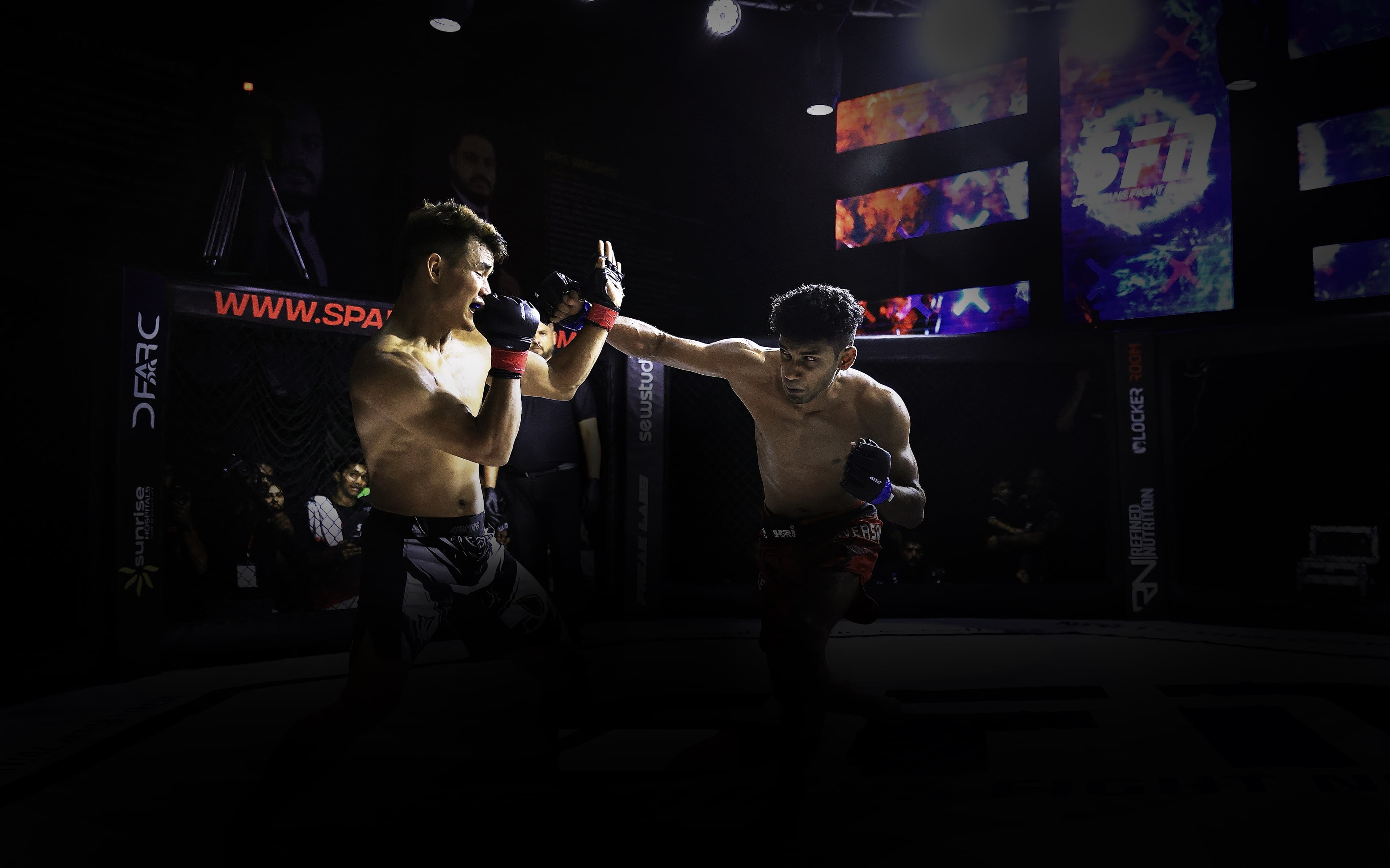 Two fighters competing in an MMA bout